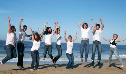 The Nautical yearbook team having a fun group photo at the beach